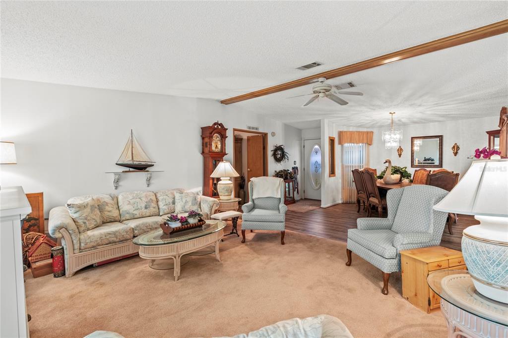 83 Eagle Circle Ellenton, FL 34222 - Photo 5 of 60 a living room with furniture a rug and a chandelier