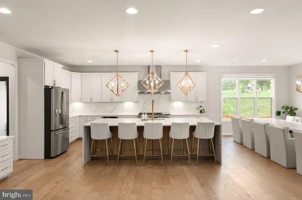 a large kitchen with a table and chairs