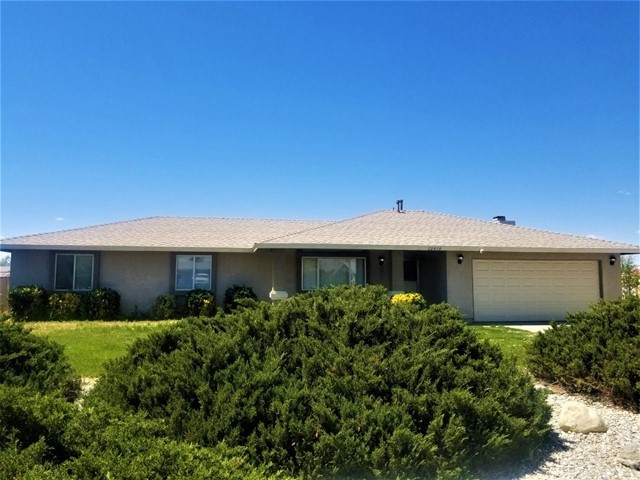 12810 Algonquin Road Apple Valley, CA 92308 - Photo 1 of 1 a front view of a house with garden