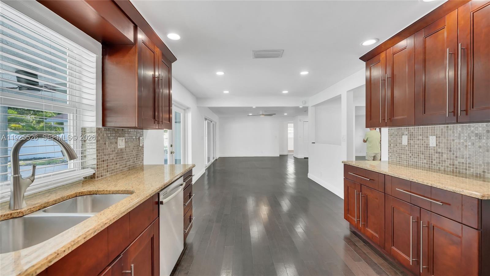 620 Northeast 2nd Street Pompano Beach, FL 33060 - Photo 18 of 53 a kitchen with stainless steel appliances granite countertop a sink stove and cabinets