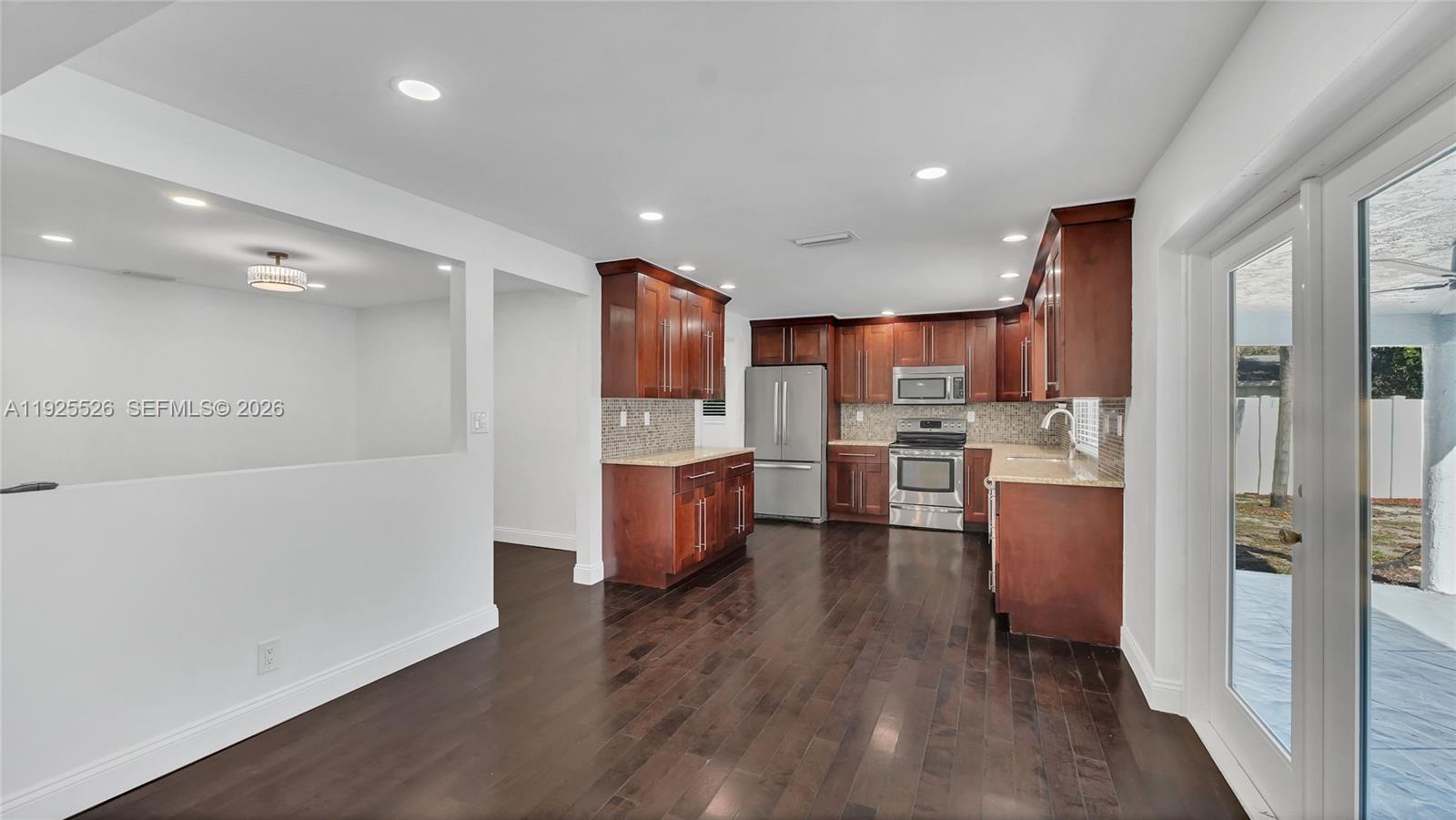 620 Northeast 2nd Street Pompano Beach, FL 33060 - Photo 20 of 53 a kitchen with stainless steel appliances a refrigerator sink and cabinets