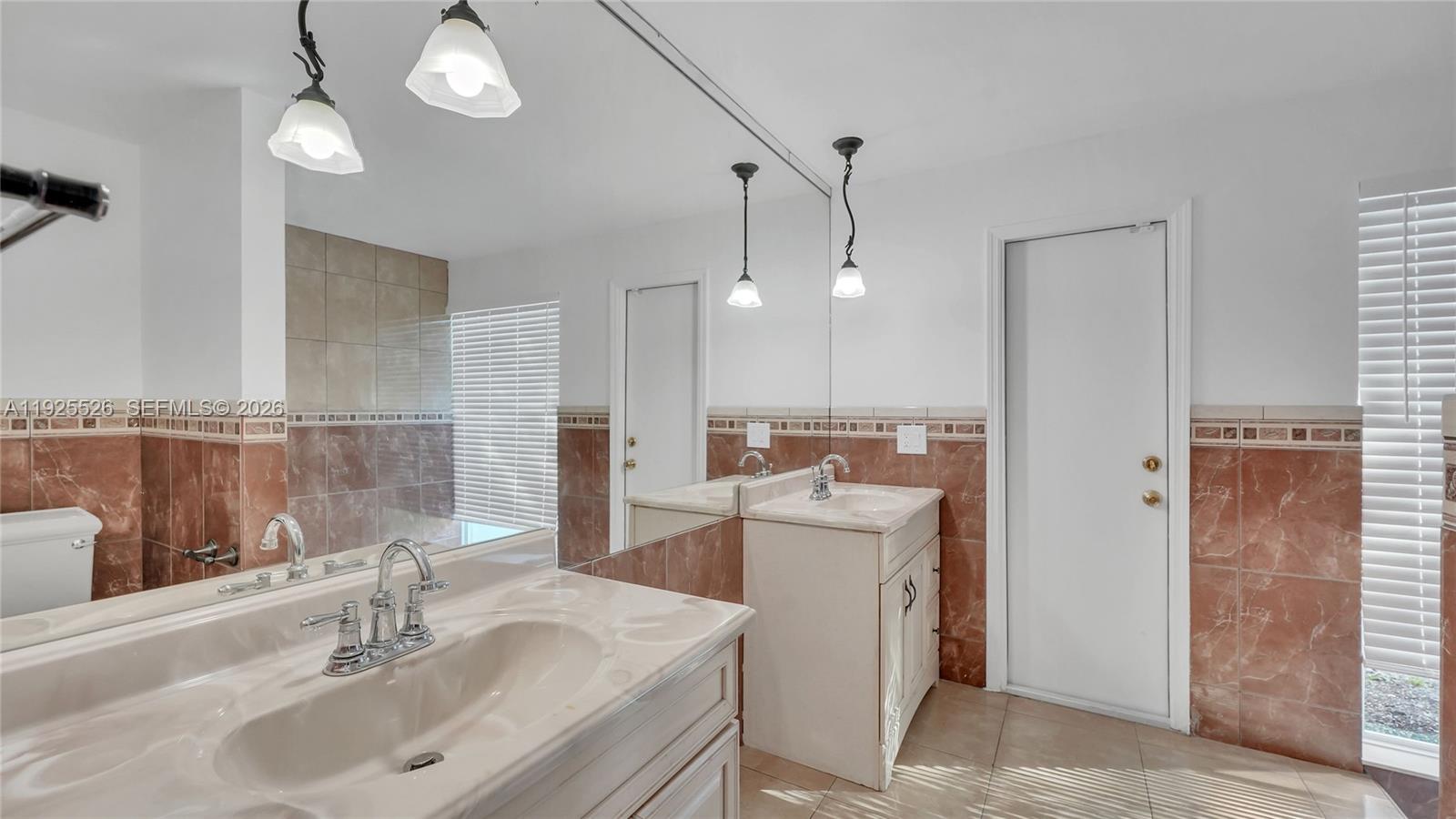 620 Northeast 2nd Street Pompano Beach, FL 33060 - Photo 30 of 53 a bathroom with a sink a toilet and a mirror