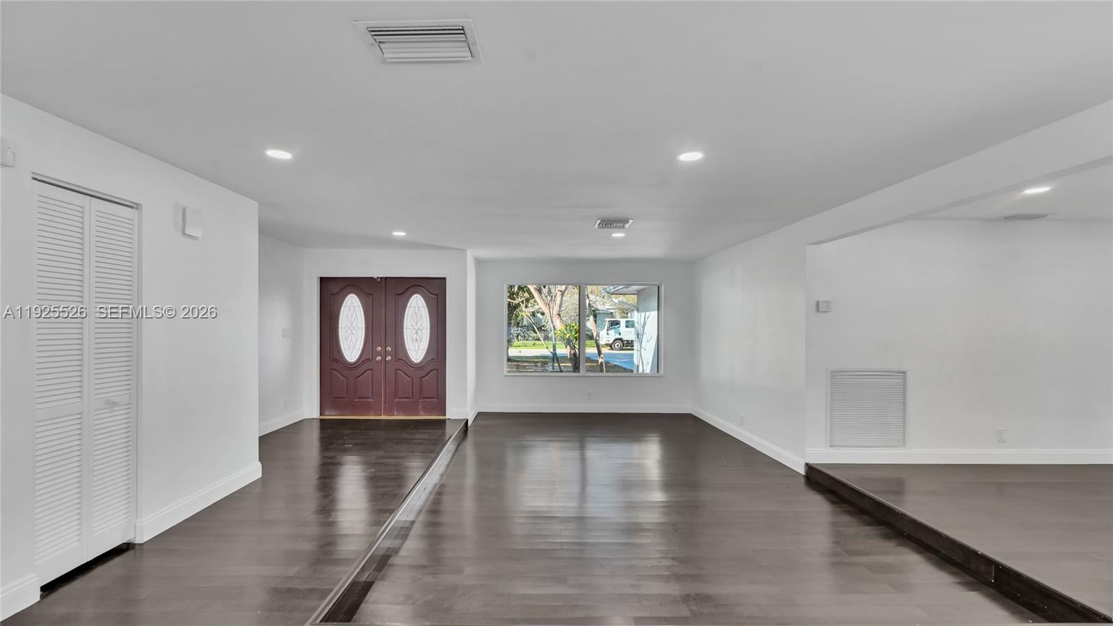 620 Northeast 2nd Street Pompano Beach, FL 33060 - Photo 9 of 53 a view of an empty room with wooden floor and a window
