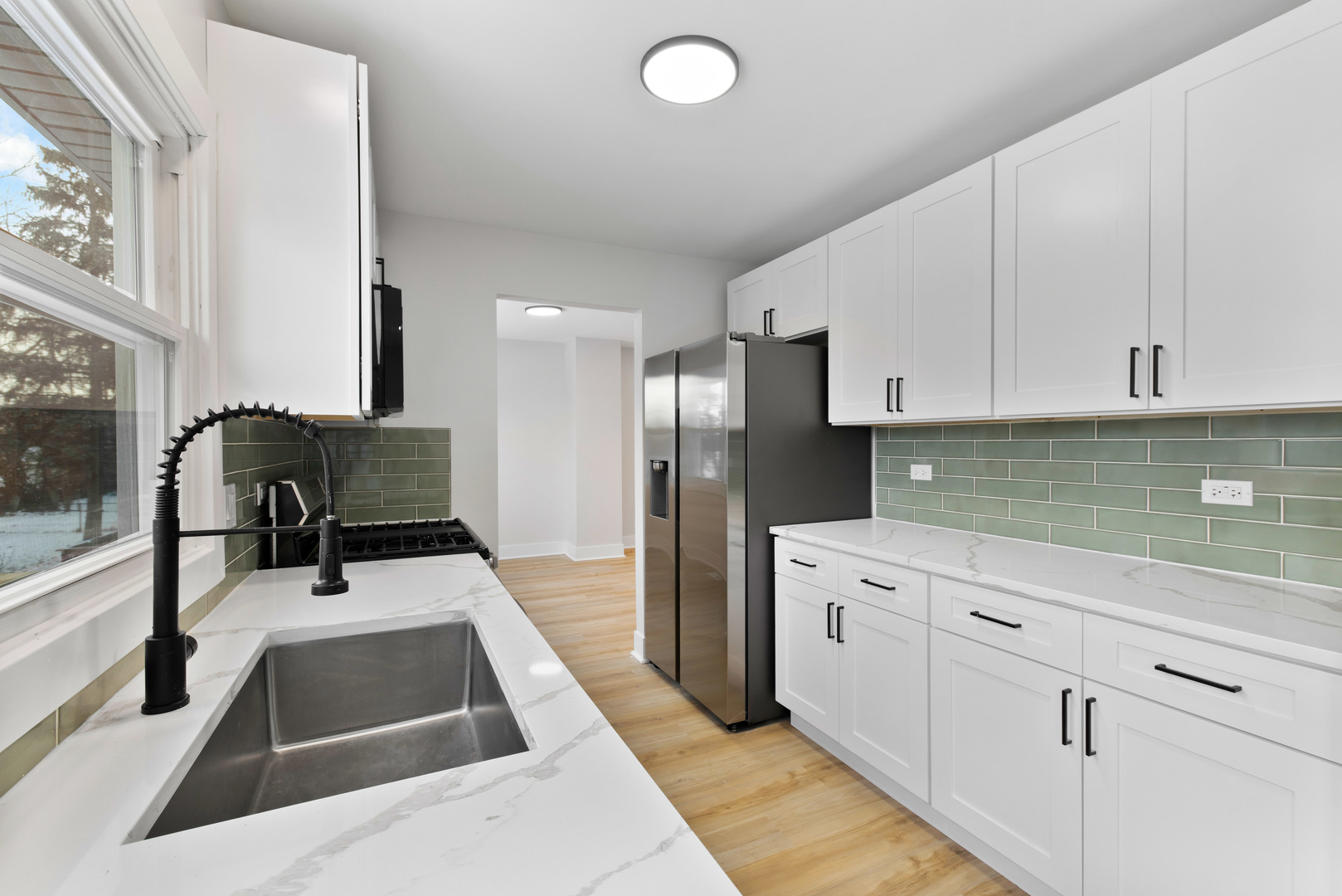 523 Nathan Road University Park, IL 60484 - Photo 14 of 43 a kitchen with stainless steel appliances kitchen island a white counter top space cabinets and a sink