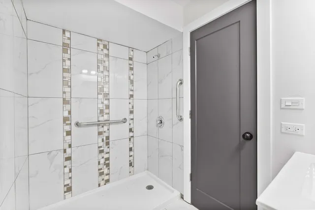 a bathroom with a shower and a glass door