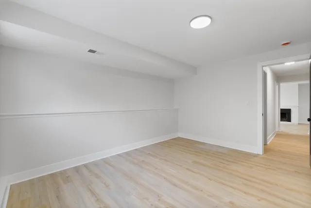 a view of a room with wooden floor