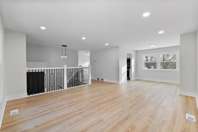 a view of a hall with wooden floor
