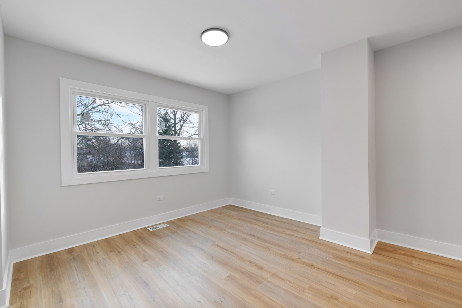523 Nathan Road University Park, IL 60484 - Photo 10 of 43 an empty room with wooden floor and windows