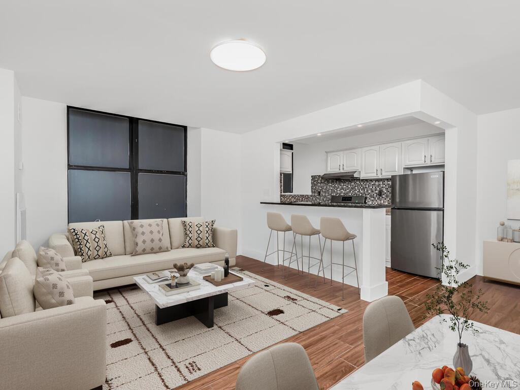 581 Academy Street, Unit GLE Manhattan, NY 10034 - Photo 1 of 18 a living room with furniture and a refrigerator