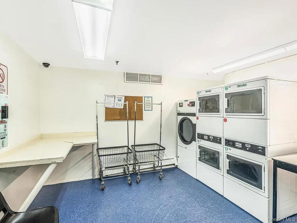 581 Academy Street, Unit GLE Manhattan, NY 10034 - Photo 11 of 18 a utility room with multiple dryer and washer