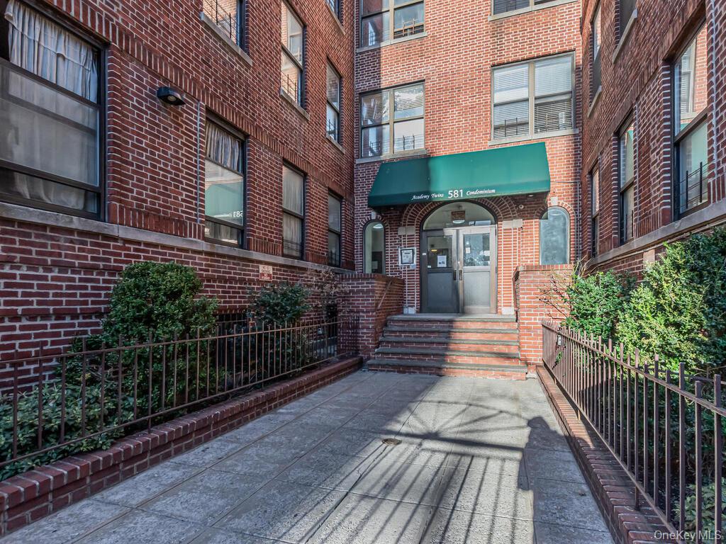 581 Academy Street, Unit GLE Manhattan, NY 10034 - Photo 13 of 18 a view of a building with many windows