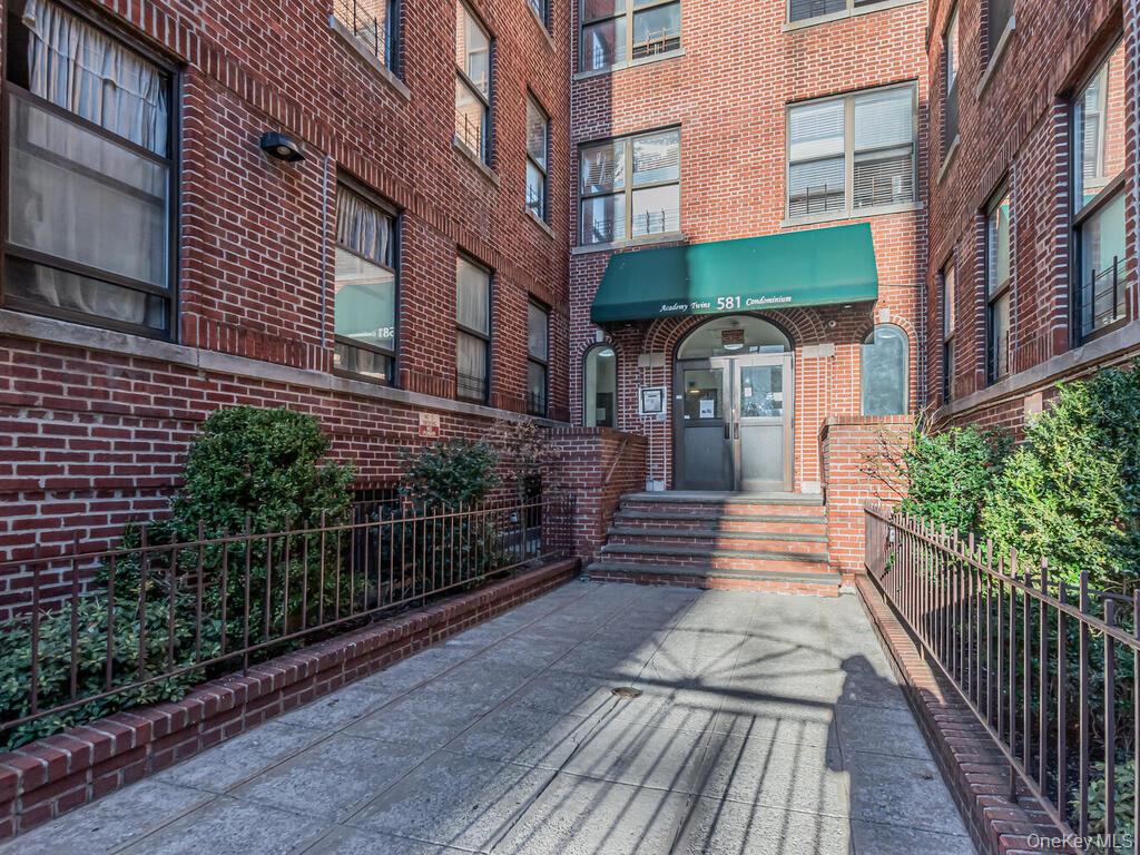 581 Academy Street, Unit GLE Manhattan, NY 10034 - Photo 14 of 18 a view of a building with many windows