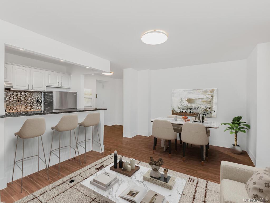 581 Academy Street, Unit GLE Manhattan, NY 10034 - Photo 2 of 18 a living room with a couch and a table