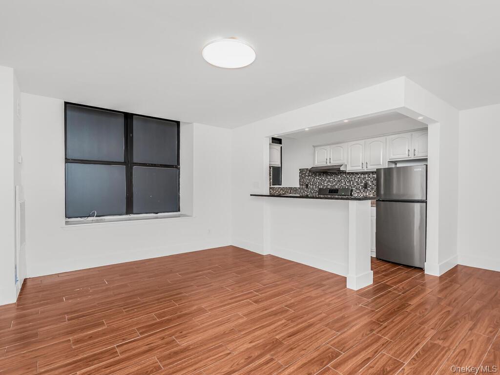 581 Academy Street, Unit GLE Manhattan, NY 10034 - Photo 3 of 18 a kitchen with stainless steel appliances a refrigerator and microwave