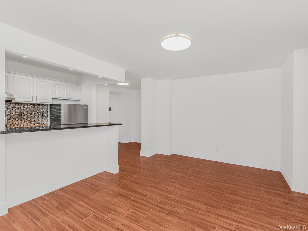 581 Academy Street, Unit GLE Manhattan, NY 10034 - Photo 4 of 18 a view of kitchen with stainless steel appliances wooden floor and cabinets
