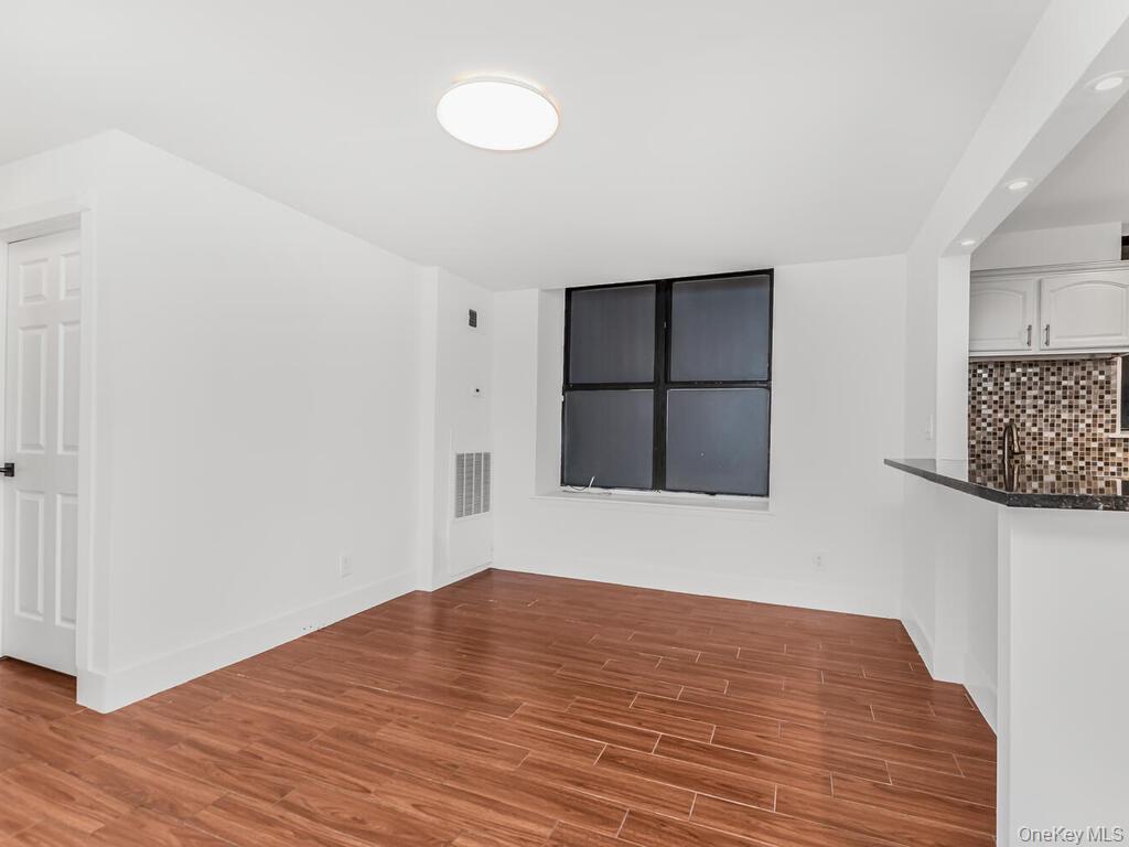 581 Academy Street, Unit GLE Manhattan, NY 10034 - Photo 5 of 18 a view of empty room with wooden floor