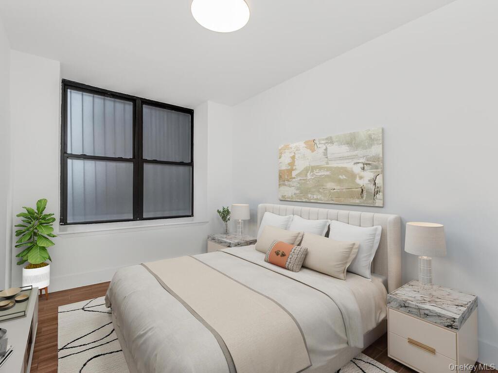 581 Academy Street, Unit GLE Manhattan, NY 10034 - Photo 7 of 18 a bedroom with a bed and a painting on the wall