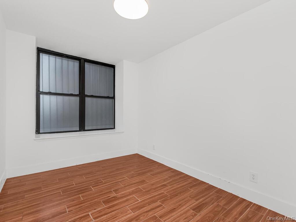 581 Academy Street, Unit GLE Manhattan, NY 10034 - Photo 8 of 18 a view of empty room with wooden floor