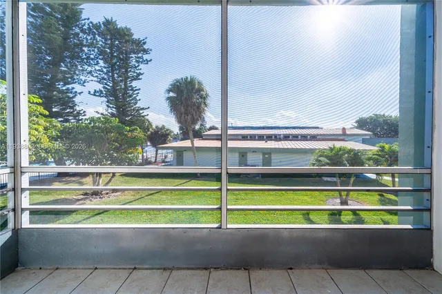 a view of a tennis ground with a large window