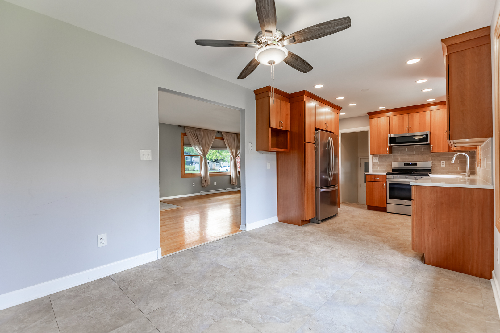 11609 North Brightway Road Mokena, IL 60448 - Photo 34 of 47 a view of a kitchen with a stove cabinets a ceiling fan and wooden floor