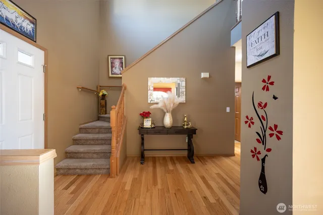 a view of entryway with stairs and wooden floor