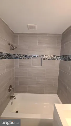 a bathroom with a shower and a bathtub