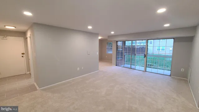 a view of an empty room with glass door