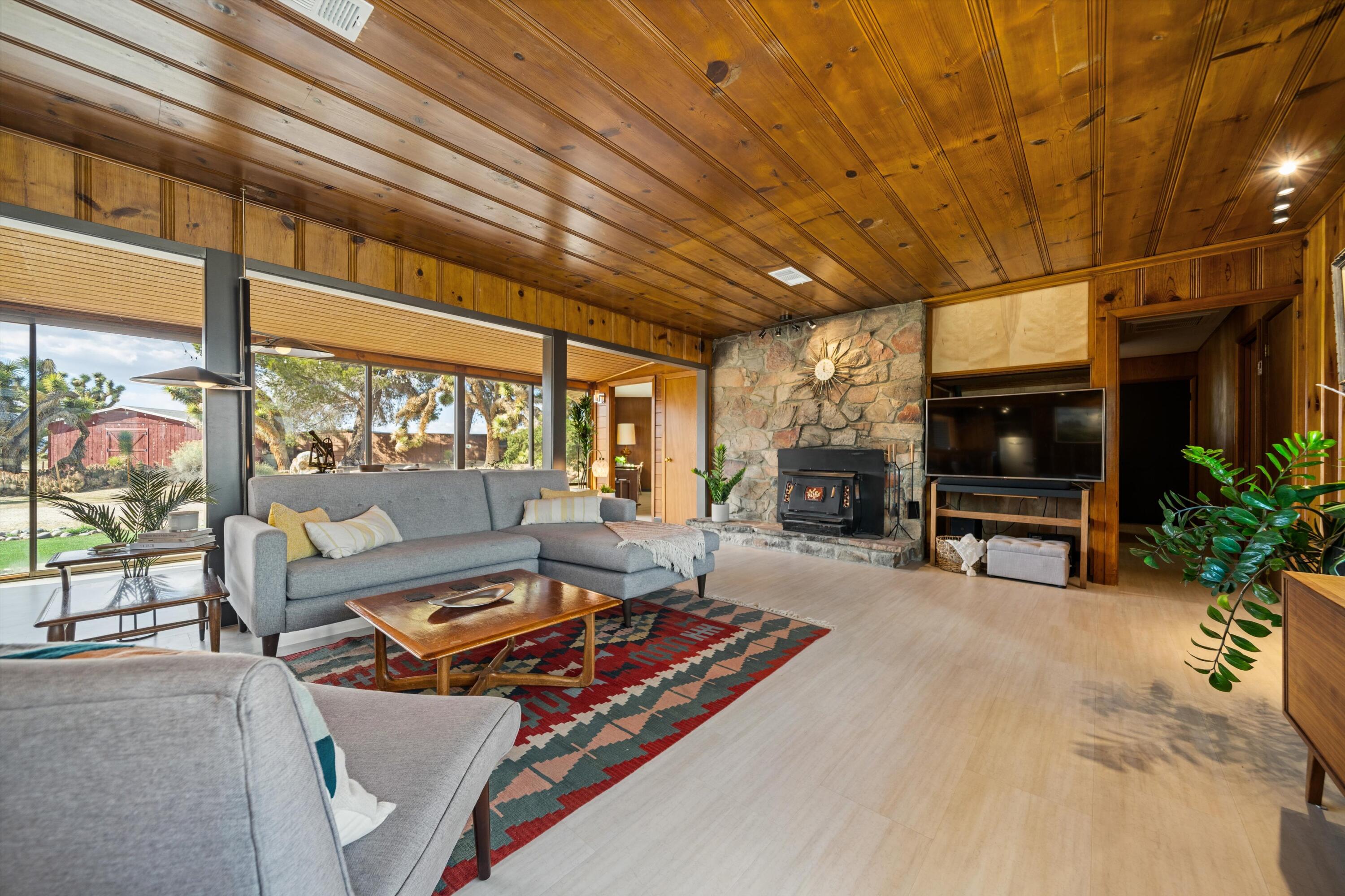 11337 Avenue E E Lancaster Ca East Lancaster, CA 93535 - Photo 11 of 60 a living room with furniture a flat screen tv and a fireplace