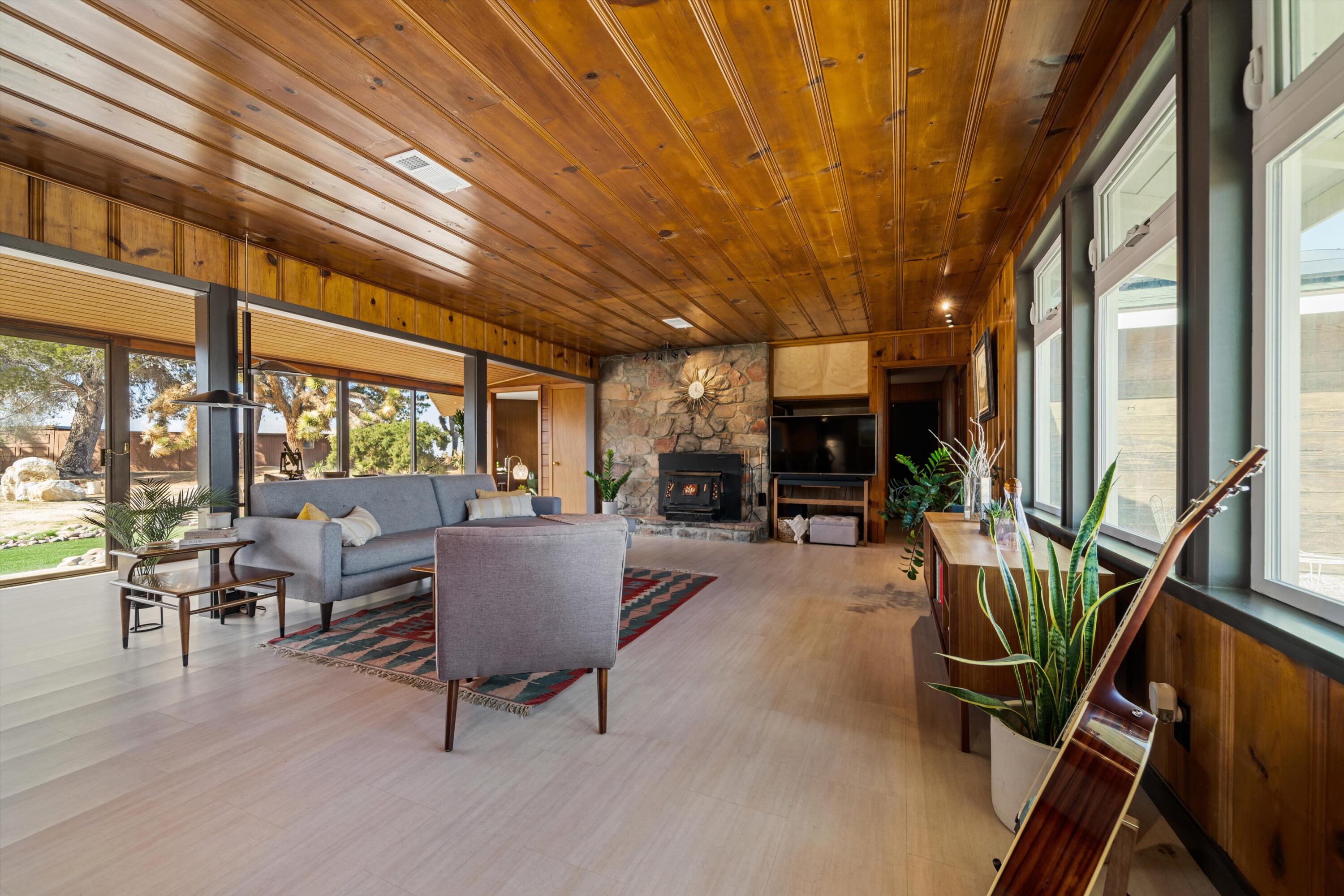 11337 Avenue E E Lancaster Ca East Lancaster, CA 93535 - Photo 14 of 60 a living room with furniture a fireplace and large windows