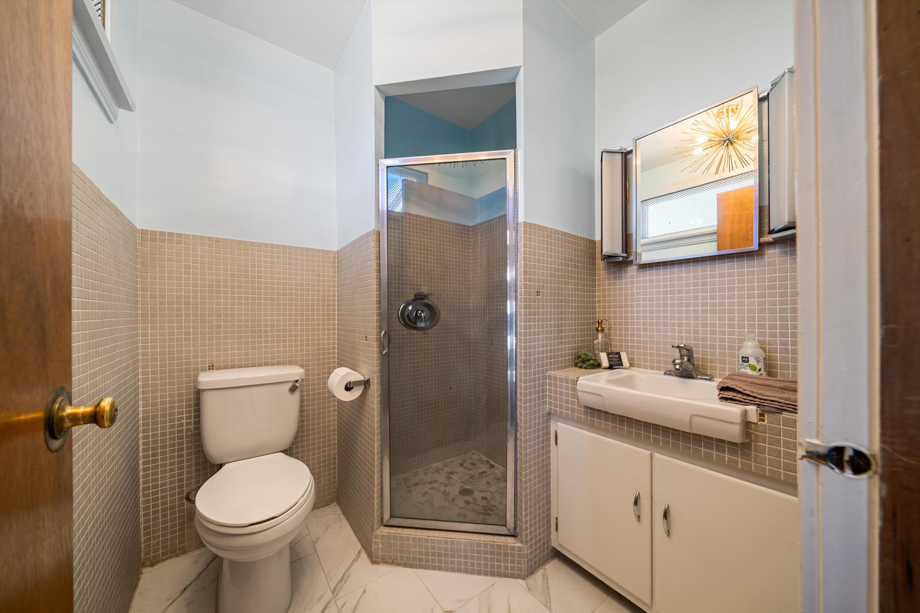 11337 Avenue E E Lancaster Ca East Lancaster, CA 93535 - Photo 16 of 60 a bathroom with a granite countertop toilet sink and shower