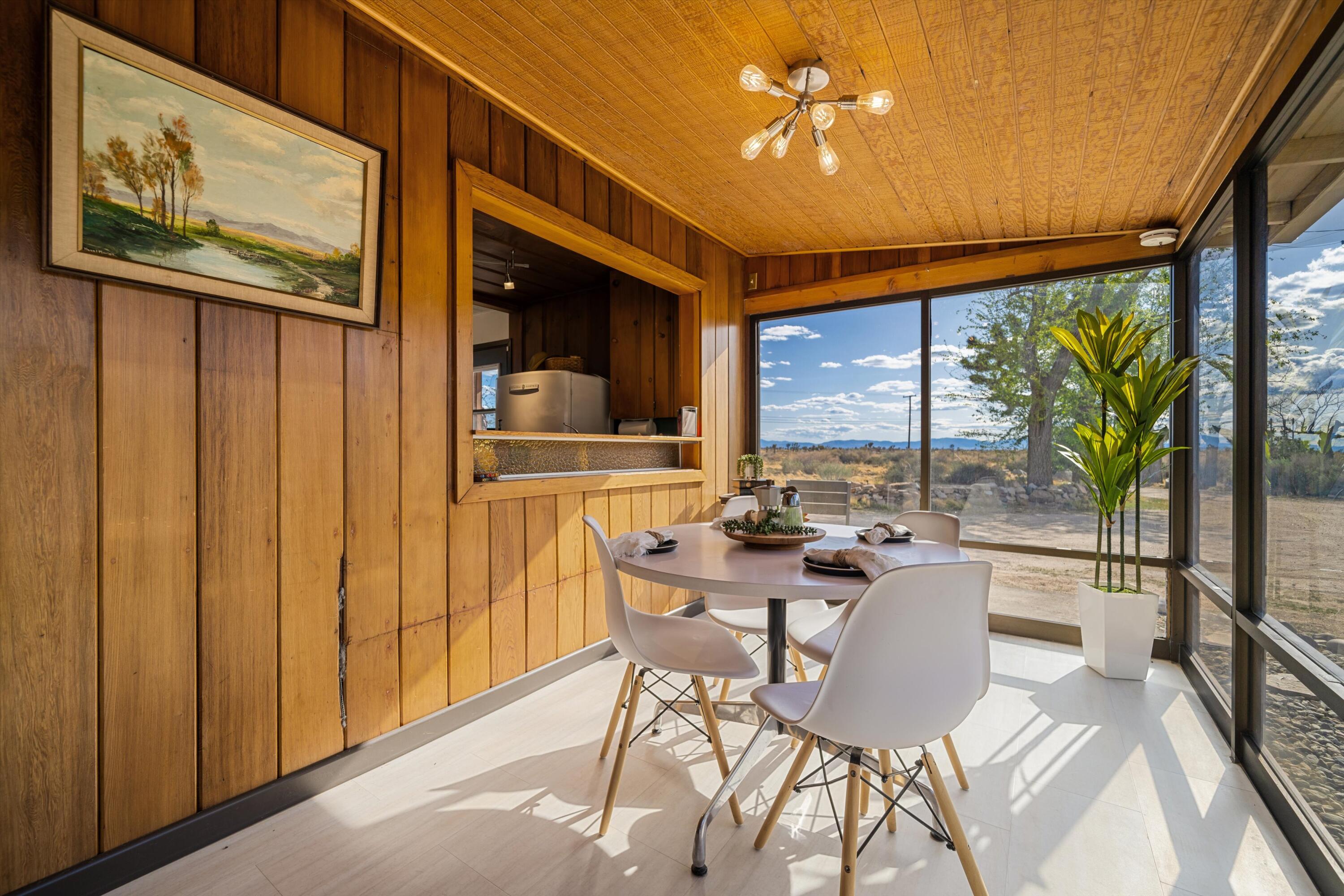 11337 Avenue E E Lancaster Ca East Lancaster, CA 93535 - Photo 17 of 60 a dining room with furniture a chandelier and wooden floor