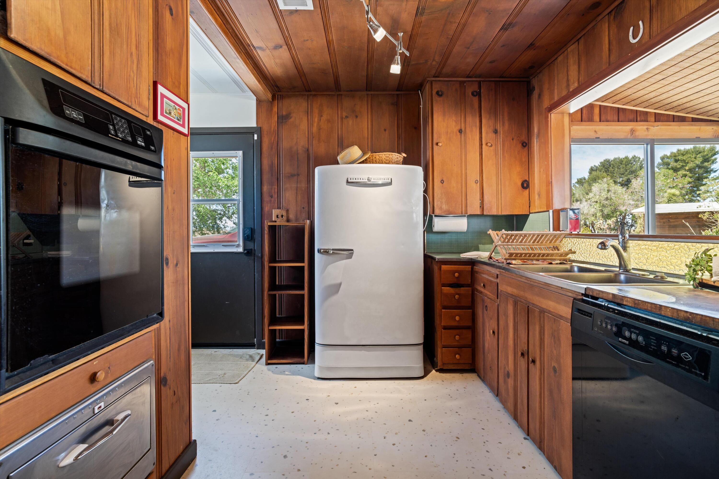 11337 Avenue E E Lancaster Ca East Lancaster, CA 93535 - Photo 19 of 60 a kitchen with a refrigerator and a stove top oven