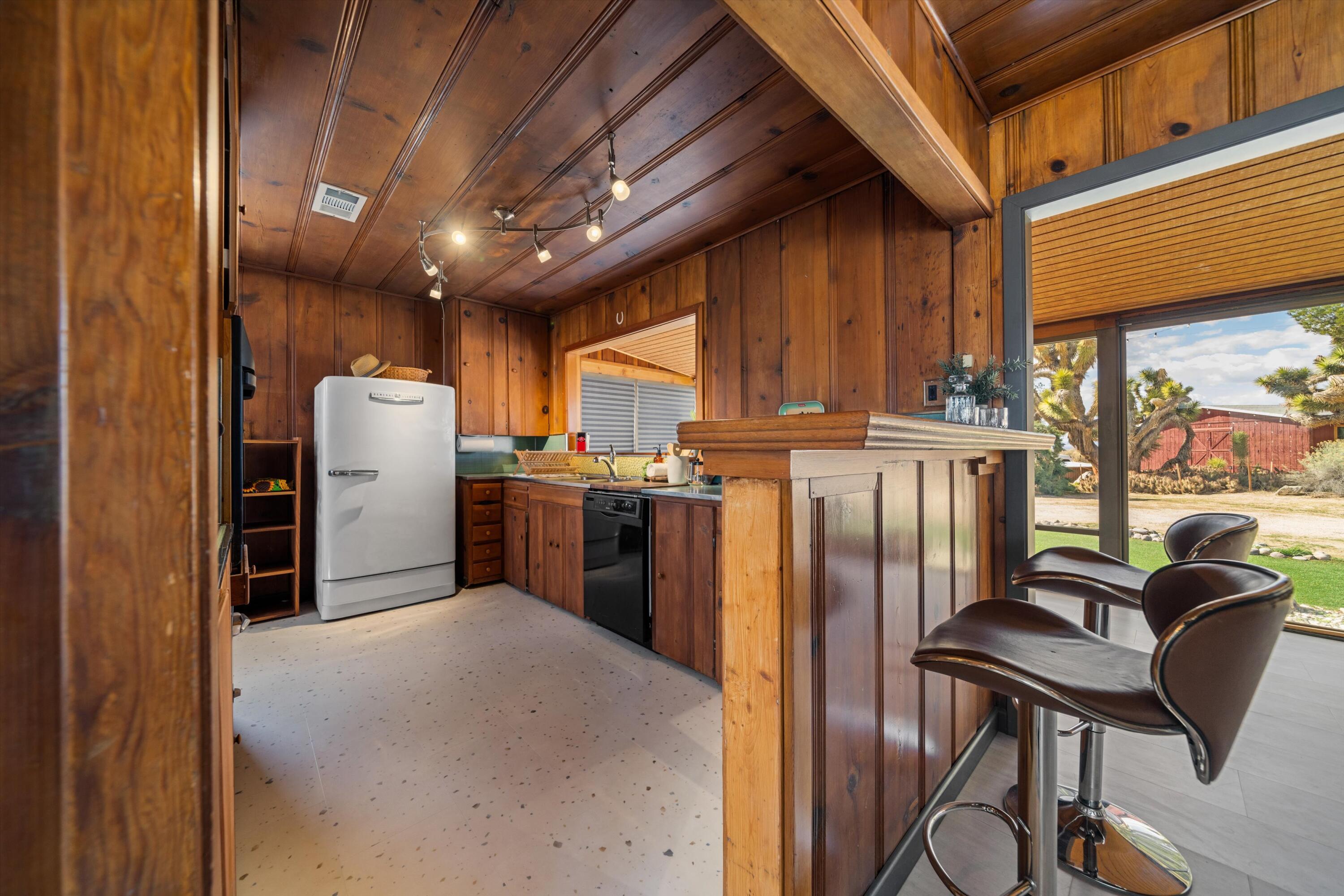 11337 Avenue E E Lancaster Ca East Lancaster, CA 93535 - Photo 20 of 60 a kitchen with refrigerator and chairs