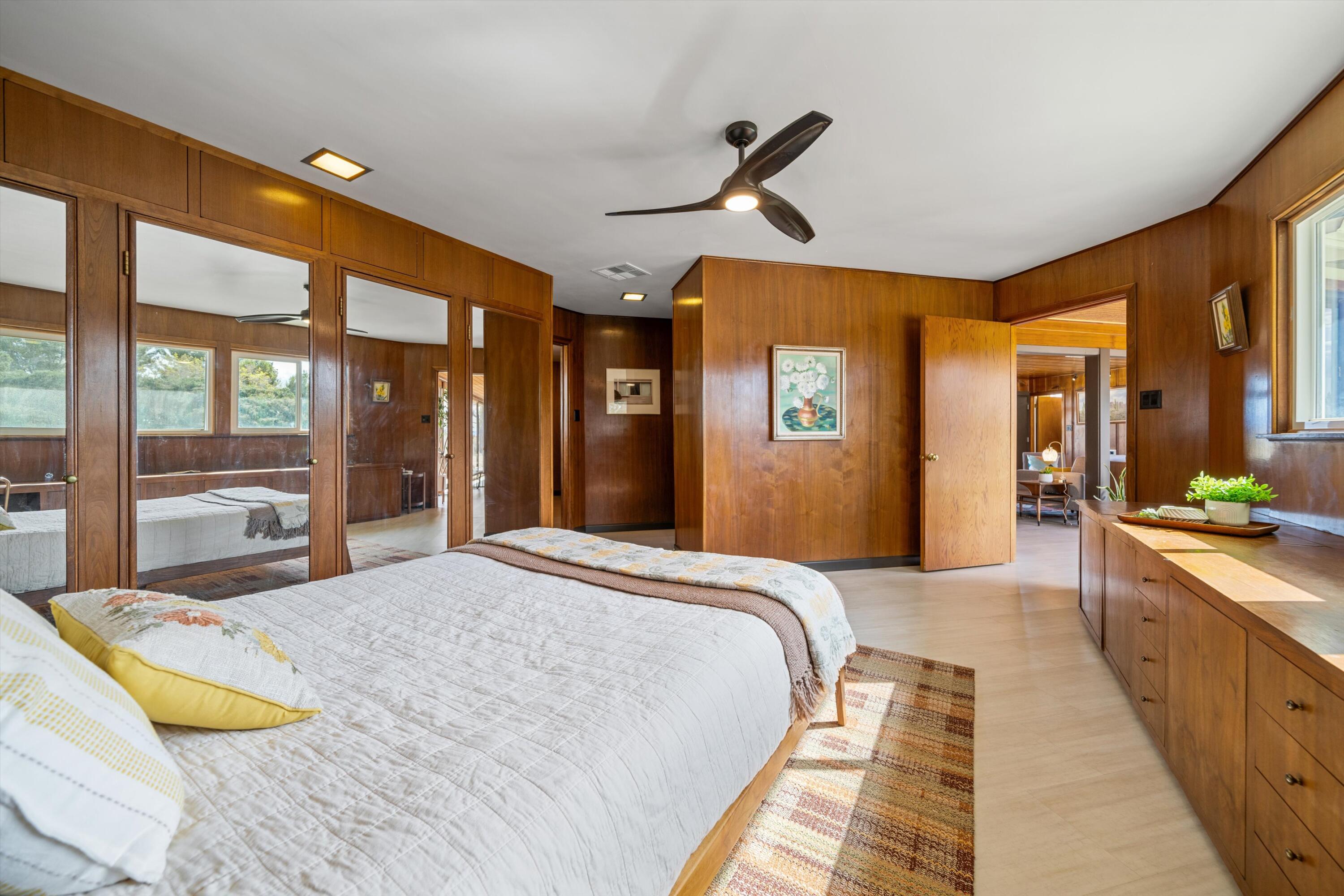 11337 Avenue E E Lancaster Ca East Lancaster, CA 93535 - Photo 31 of 60 a spacious bedroom with a large bed and a chandelier