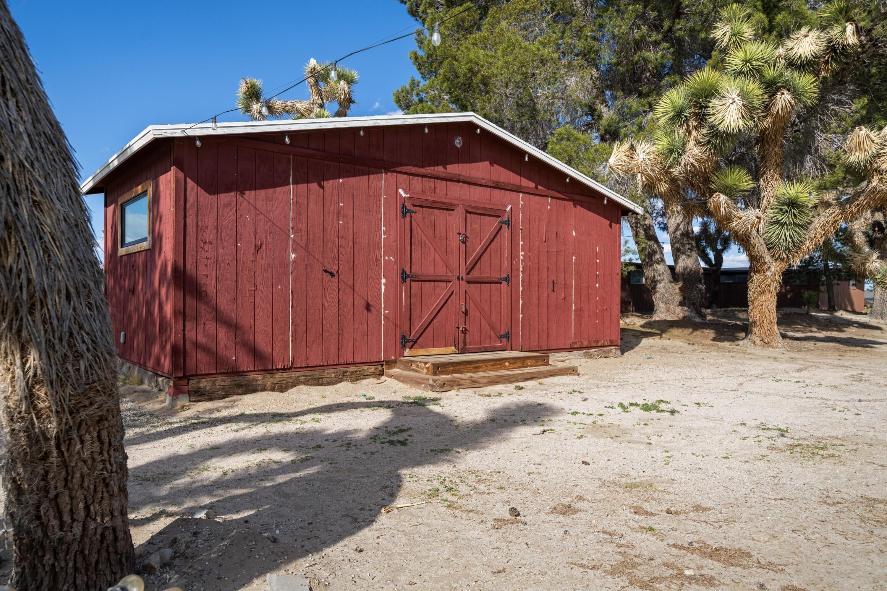 11337 Avenue E E Lancaster Ca East Lancaster, CA 93535 - Photo 42 of 60 a view of a small barn with a wooden fence