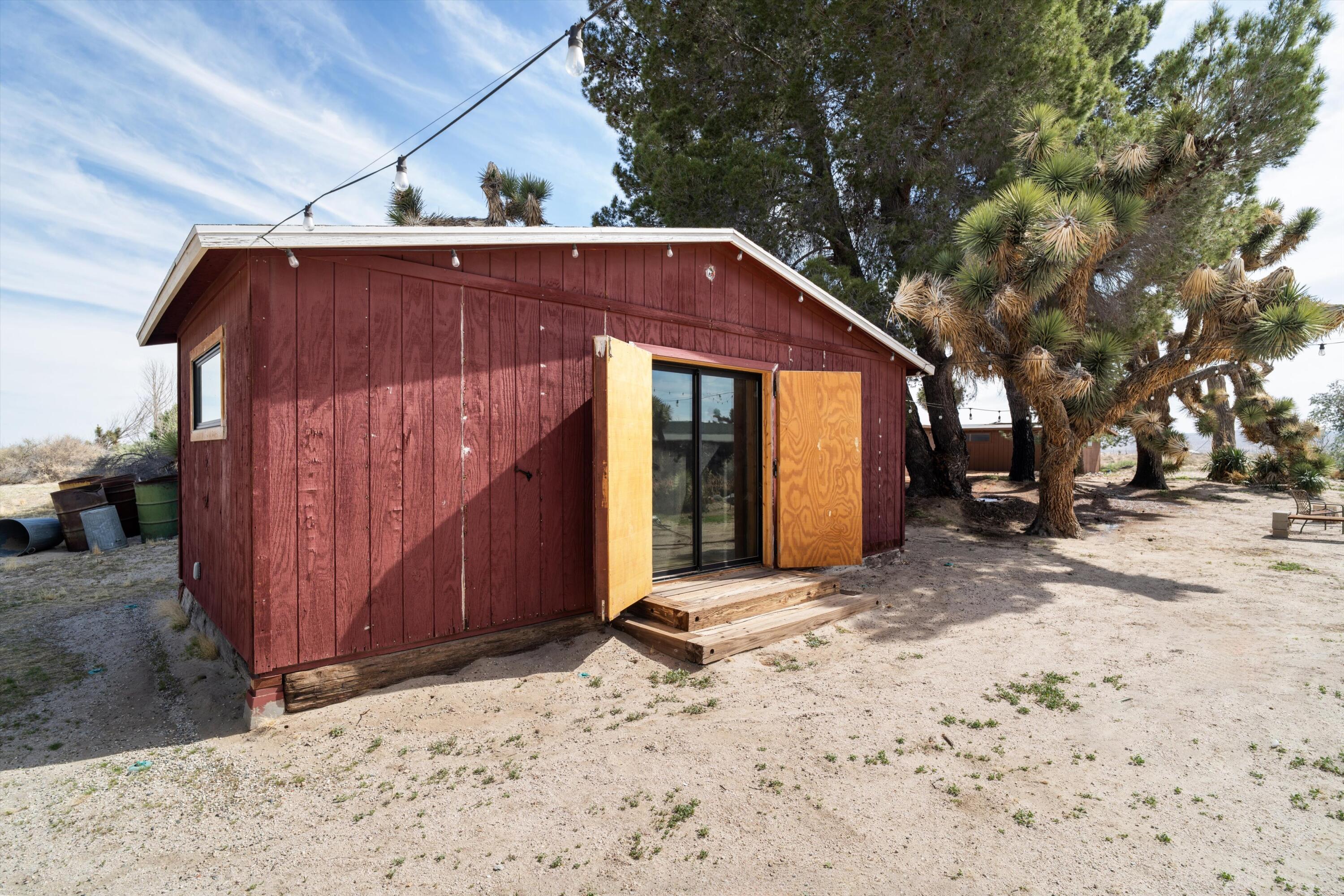 11337 Avenue E E Lancaster Ca East Lancaster, CA 93535 - Photo 44 of 60 a view of a barn with a yard