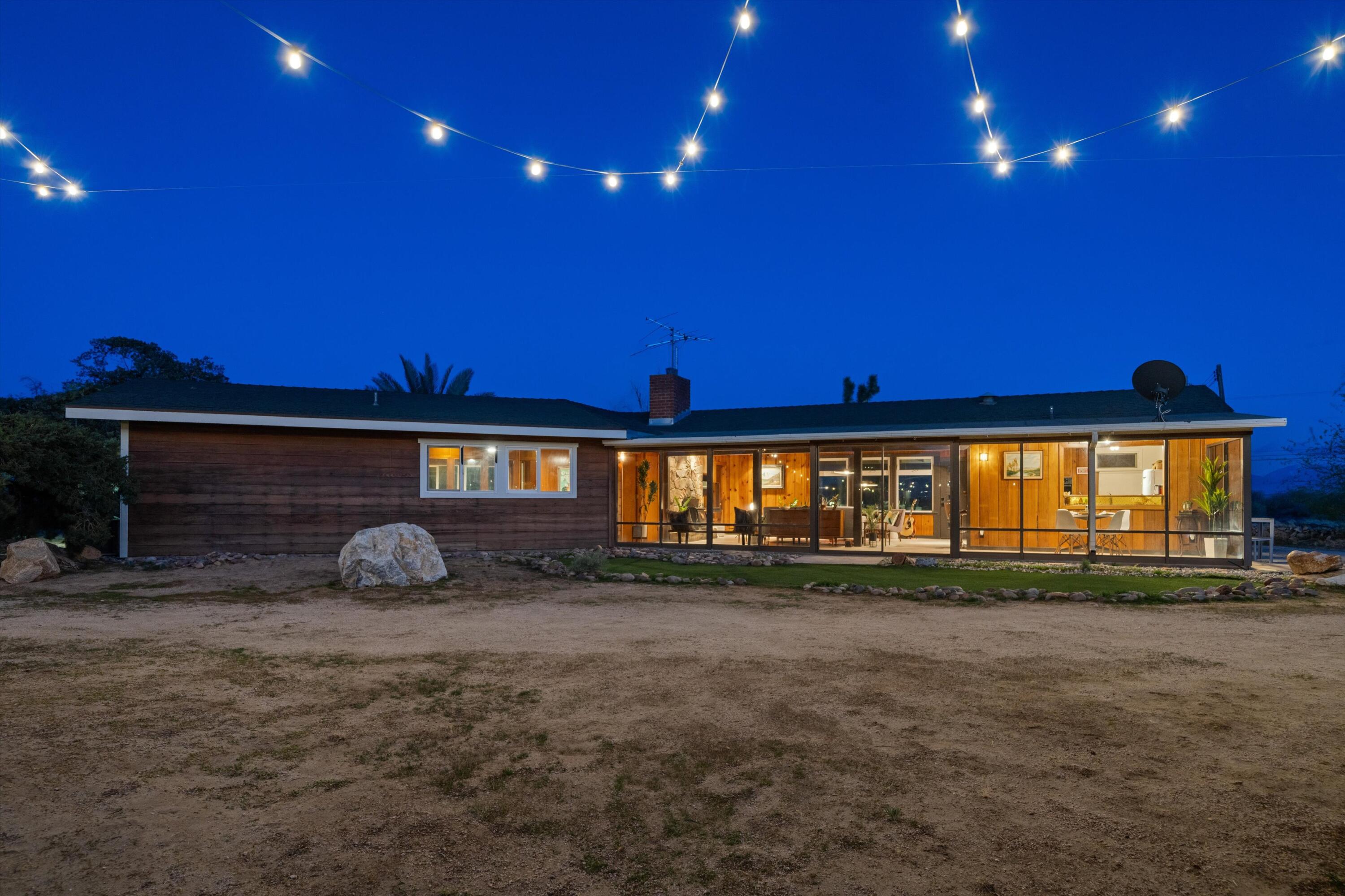 11337 Avenue E E Lancaster Ca East Lancaster, CA 93535 - Photo 59 of 60 a front view of a house with a yard and outdoor seating