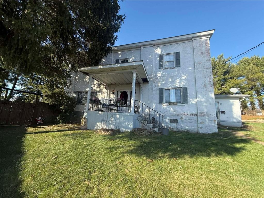 a view of a house with a yard porch and sitting area