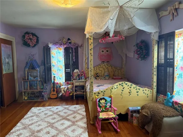 a bedroom with furniture and a window