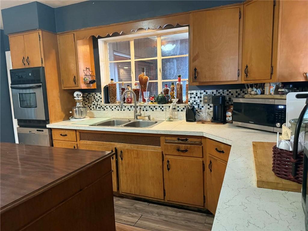 27 Legion Street Republic, PA 15475 - Photo 9 of 31 a kitchen with stainless steel appliances granite countertop a sink and a stove