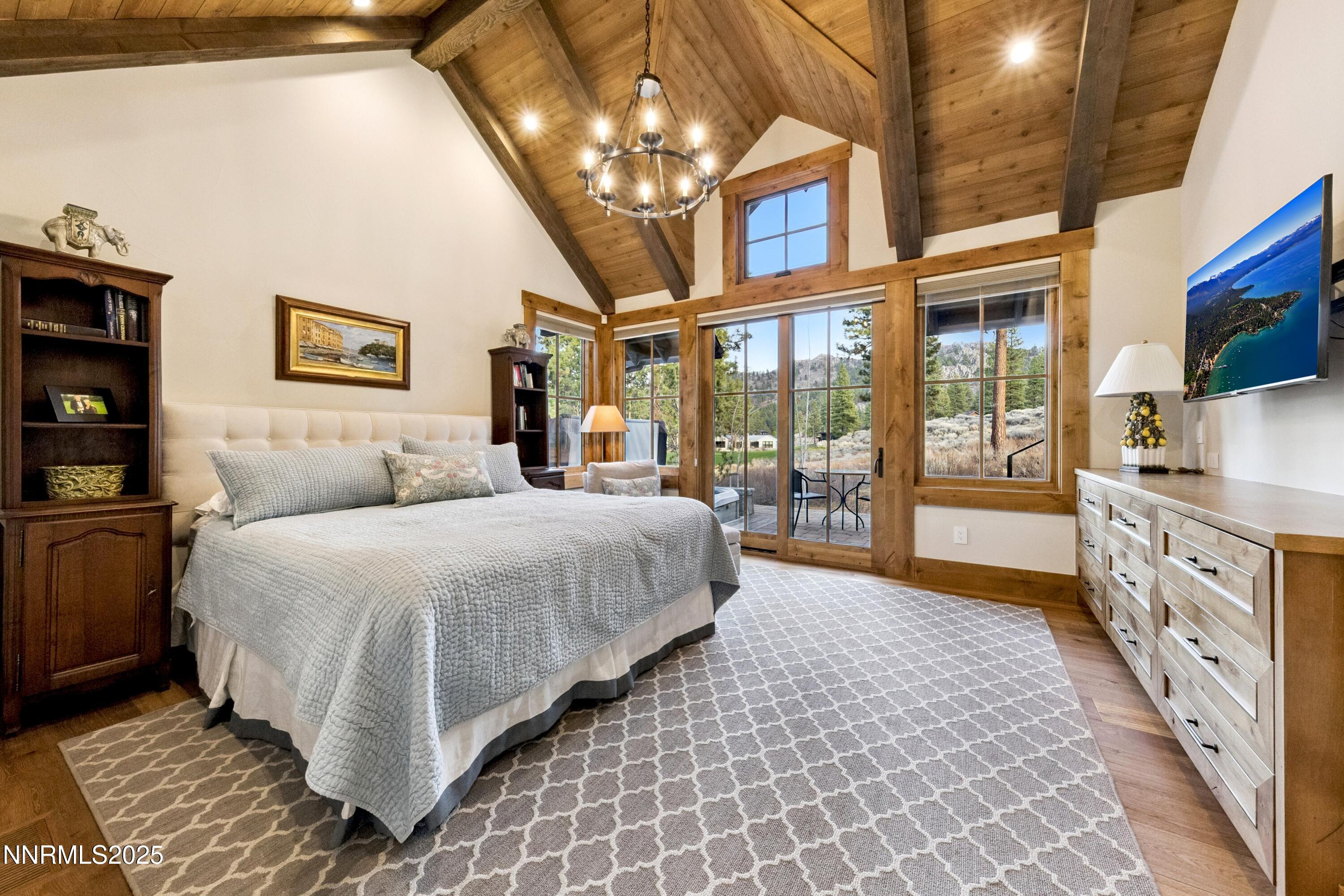 261 Redding Way Carson City, NV 89705 - Photo 28 of 83 a spacious bedroom with a large bed and a chandelier