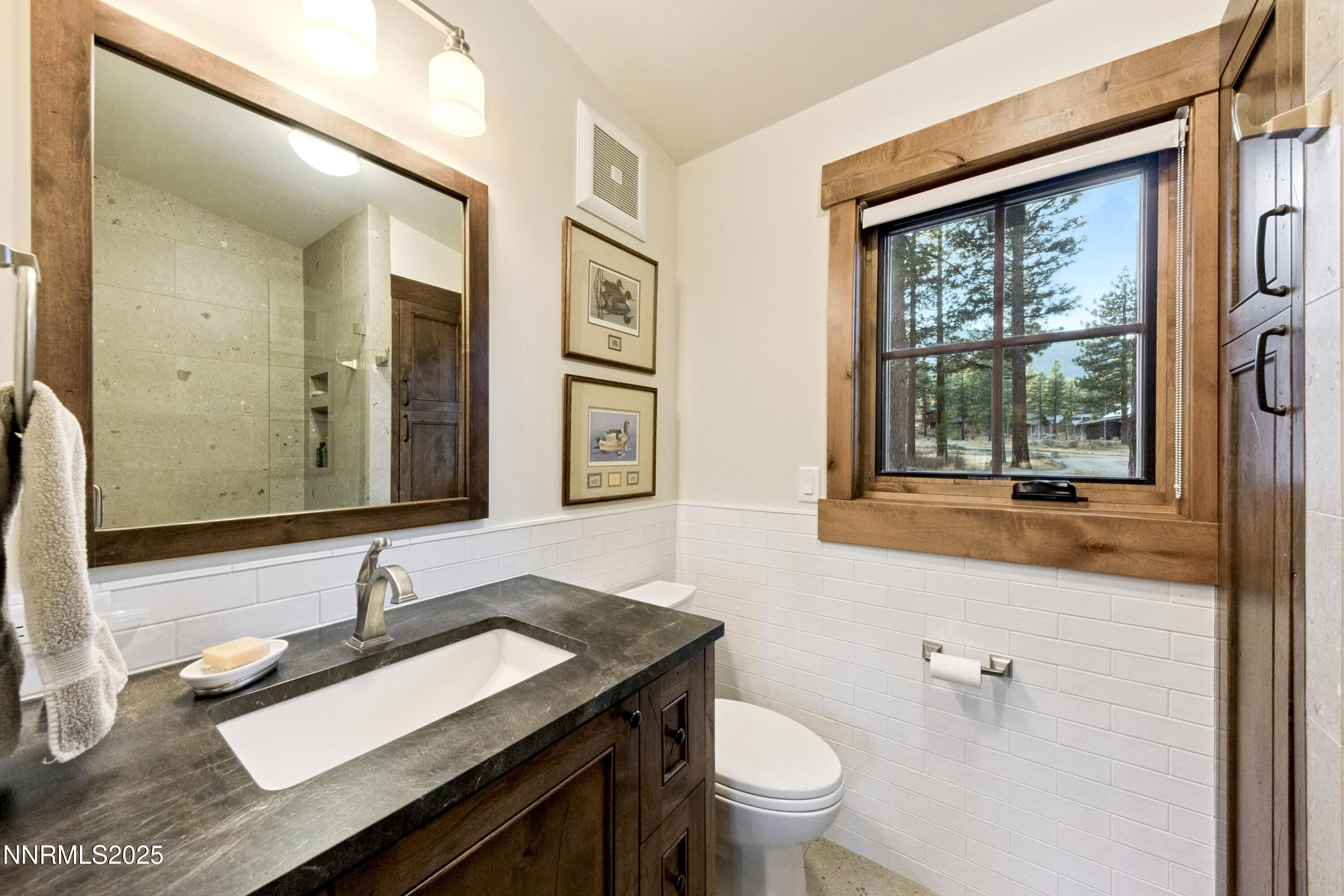 261 Redding Way Carson City, NV 89705 - Photo 49 of 83 a bathroom with a granite countertop sink and a large mirror