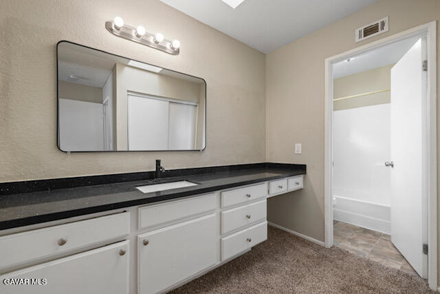 523 East Kettering Street Lancaster, CA 93535 - Photo 11 of 28 a bathroom with a sink and a mirror