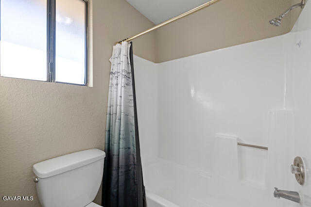 523 East Kettering Street Lancaster, CA 93535 - Photo 13 of 28 a bathroom with a toilet and a shower