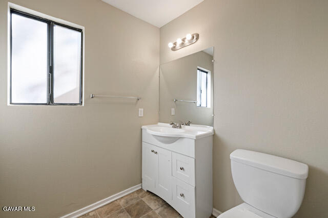 523 East Kettering Street Lancaster, CA 93535 - Photo 16 of 28 a view of bathroom with a toilet sink and mirror