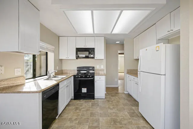 a kitchen with a refrigerator sink and stove