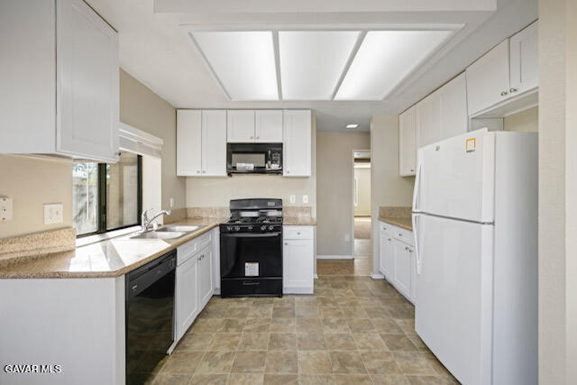 523 East Kettering Street Lancaster, CA 93535 - Photo 5 of 28 a kitchen with a refrigerator sink and stove