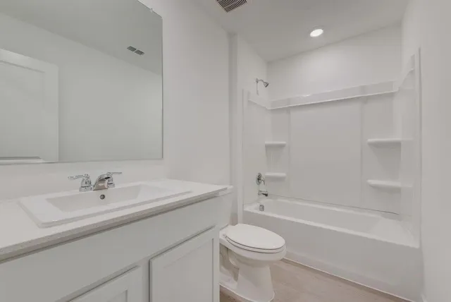 a bathroom with a sink a toilet and a bathtub