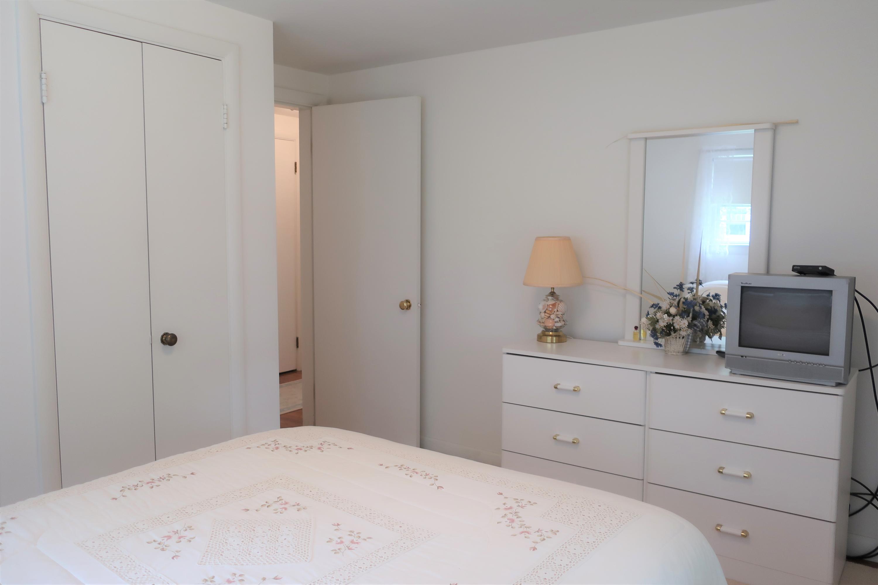 19 Bacon Road Hyannis, MA 02601 - Photo 13 of 23 a bedroom with a bed and a dresser in it