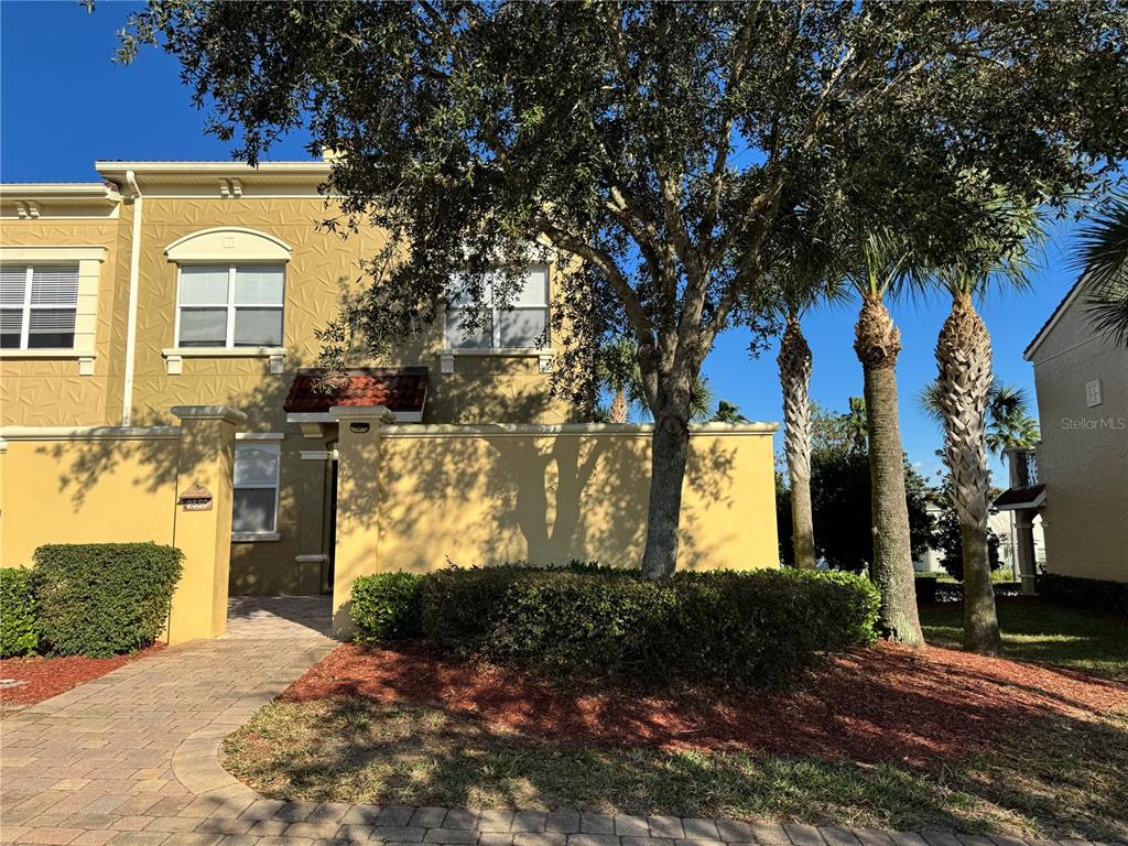 a front view of a house with a yard and tree s